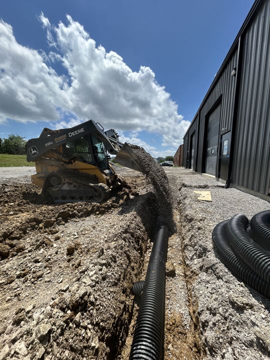 Drainage pipe installation beside a building